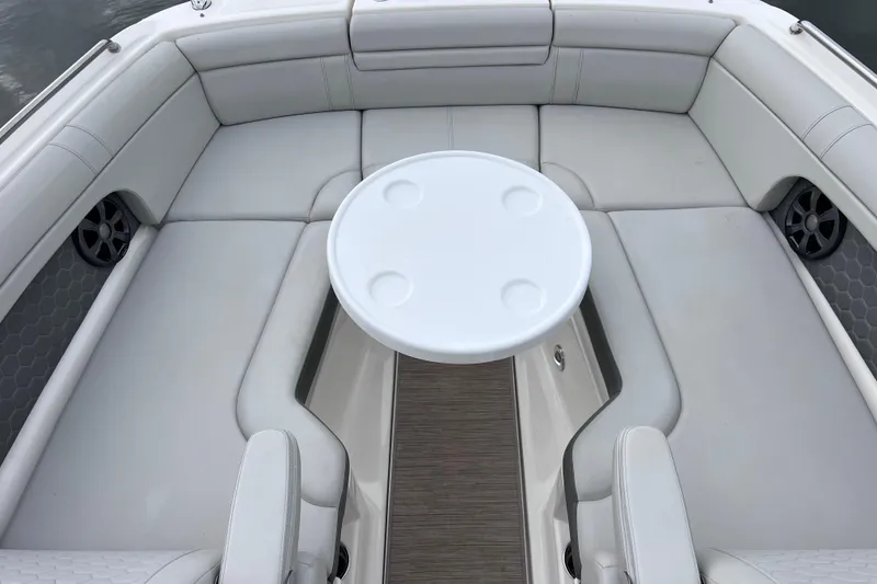 Slide: The Image of 2020 Sea Ray SDX 270 Outboard boat interior with white seating and round table. - 31