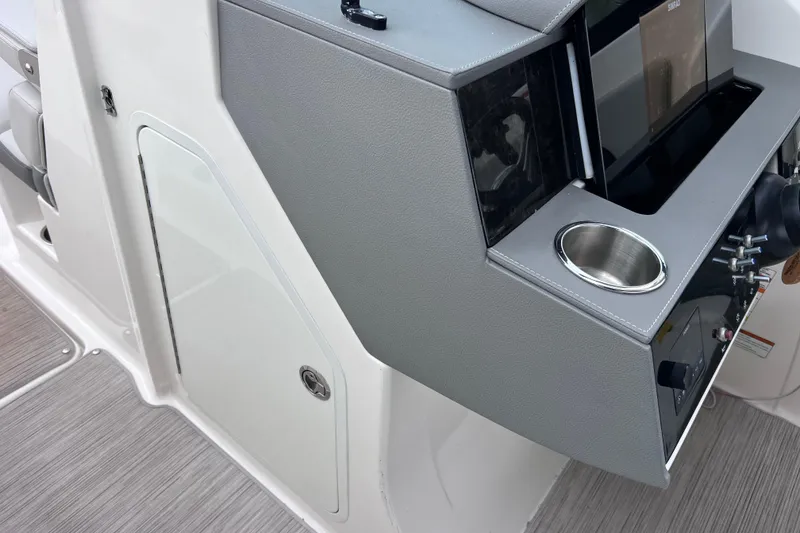 Slide: The Image of 2020 Sea Ray SDX 270 Outboard helm with modern controls and cup holder. - 38
