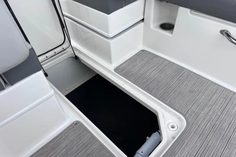 Slide: The Image of 2020 Sea Ray SDX 270 Outboard boat interior with open storage compartment. - 46