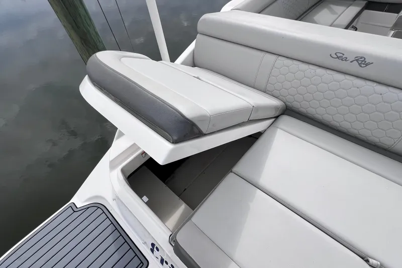 Slide: The Image of 2020 Sea Ray SDX 270 Outboard boat with open storage compartment and cushioned seating. - 47