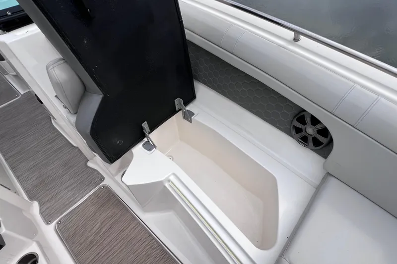 Slide: The Image of 2020 Sea Ray SDX 270 Outboard boat interior storage compartment with speaker. - 48