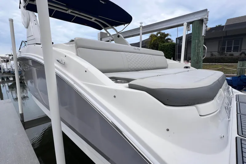 Slide: The Image of 2020 Sea Ray SDX 270 Outboard boat docked, featuring sleek design and comfortable seating. - 7