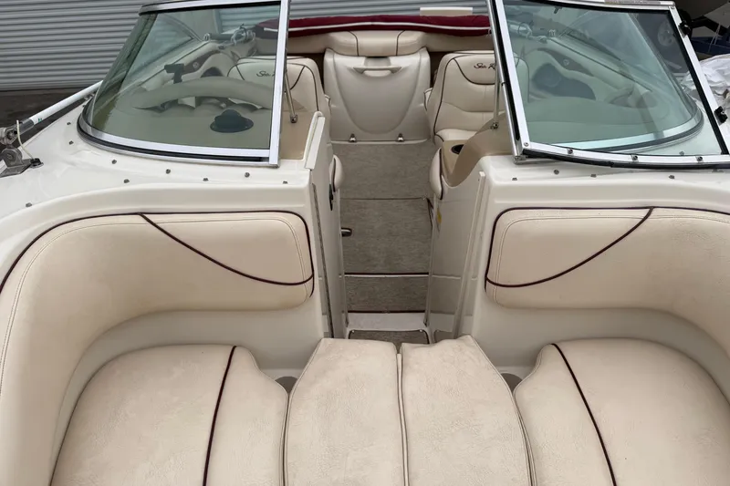 Slide: The Image of Interior view of a 2000 Sea Ray 210 Bow Rider boat with beige seating. - 10