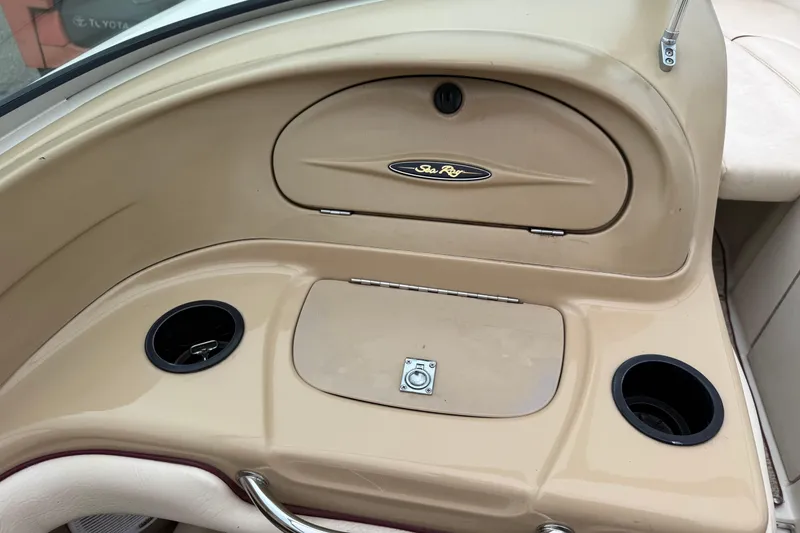 Slide: The Image of Interior of a 2000 Sea Ray 210 Bow Rider boat with storage compartment and cup holders. - 15