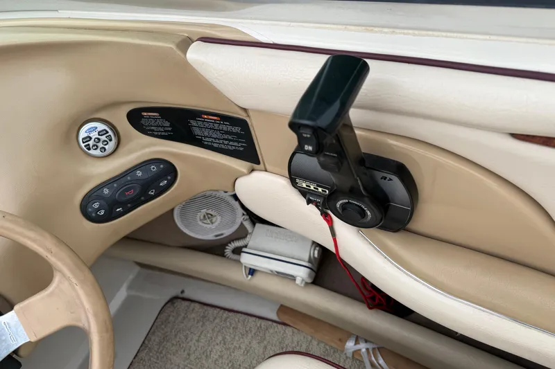 Slide: The Image of Interior controls of a 2000 Sea Ray 210 Bow Rider boat, featuring throttle and audio system. - 18