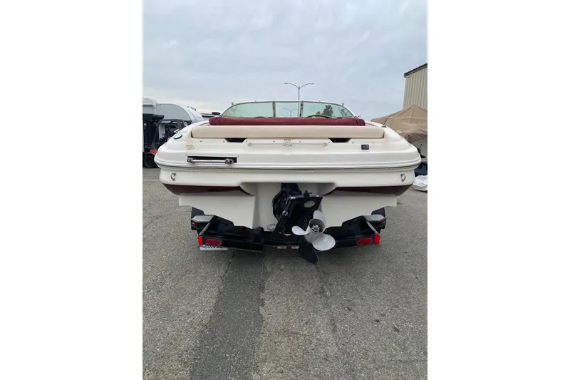 Slide: The Image of 2000 Sea Ray 210 Bow Rider boat, rear view, parked on trailer. - 6