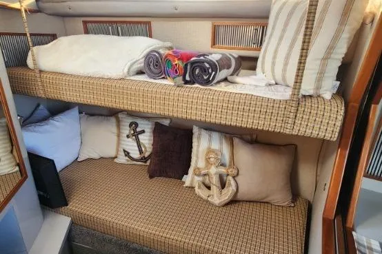 Slide: The Image of 1988 Sea Ray 390 Express Cruiser cabin with cozy bunk beds and nautical decor. - 26
