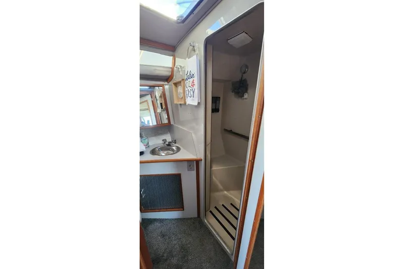 Slide: The Image of 1988 Sea Ray 390 Express Cruiser bathroom with sink and shower. - 34