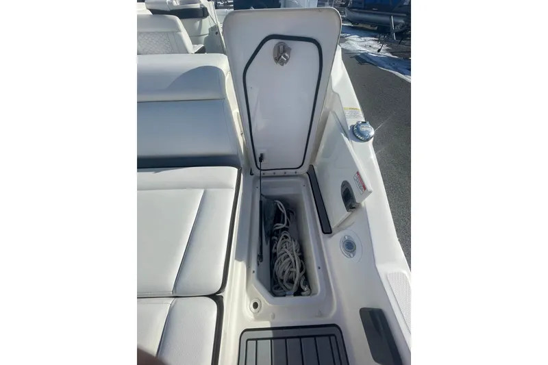 Slide: The Image of 2020 Sea Ray SDX 270 Outboard boat storage compartment with rope inside. - 11