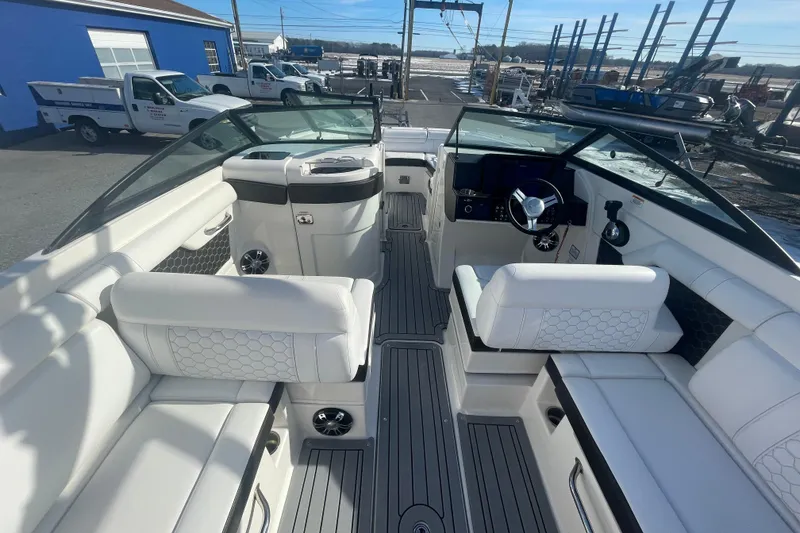 Slide: The Image of 2020 Sea Ray SDX 270 Outboard interior with white seating and modern dashboard. - 14