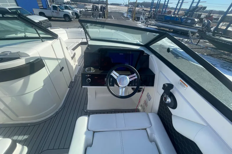 Slide: The Image of 2020 Sea Ray SDX 270 Outboard boat interior with steering wheel and seating area. - 16