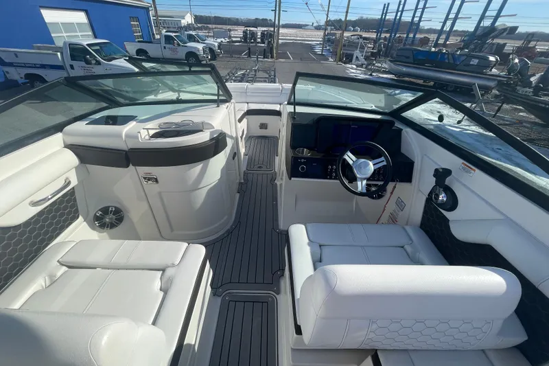 Slide: The Image of 2020 Sea Ray SDX 270 Outboard boat interior with white seating and modern dashboard. - 17