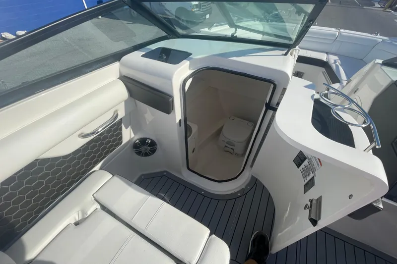 Slide: The Image of 2020 Sea Ray SDX 270 Outboard interior with seating and storage compartment. - 18