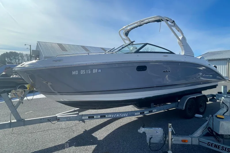 Slide: The Image of 2020 Sea Ray SDX 270 Outboard boat on trailer, parked outdoors. - 3