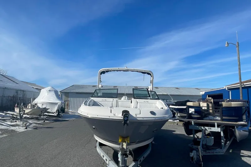 Slide: The Image of 2020 Sea Ray SDX 270 Outboard boat on trailer under clear blue sky. - 4