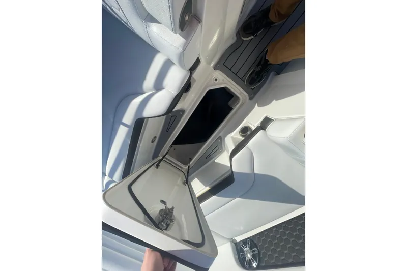 Slide: The Image of 2020 Sea Ray SDX 270 Outboard interior storage compartment with open hatch. - 5