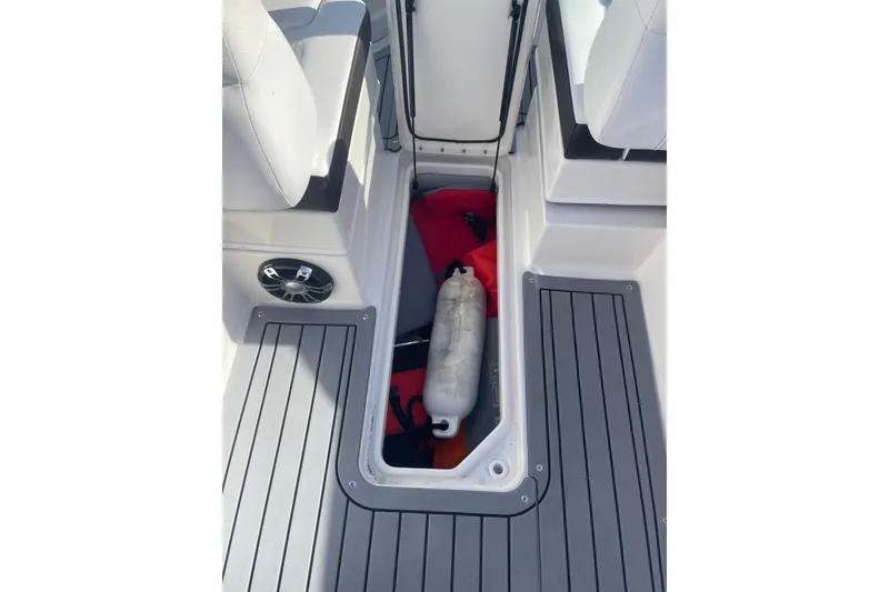 Slide: The Image of 2020 Sea Ray SDX 270 Outboard storage compartment with life jacket and fender. - 6