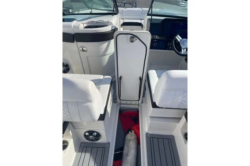 Slide: The Image of 2020 Sea Ray SDX 270 Outboard interior with white seating and modern dashboard. - 7