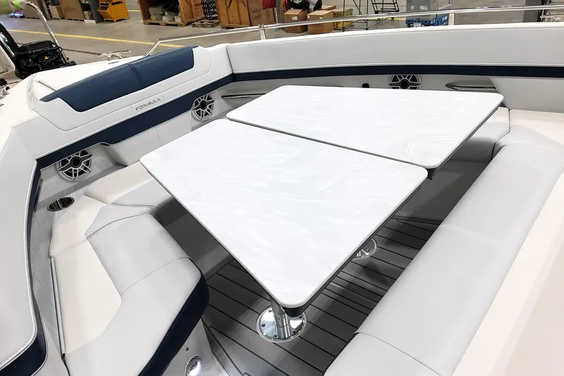 Slide: The Image of Luxury seating area on 2026 Formula 400 Super Sport Crossover boat with sleek tables. - 15