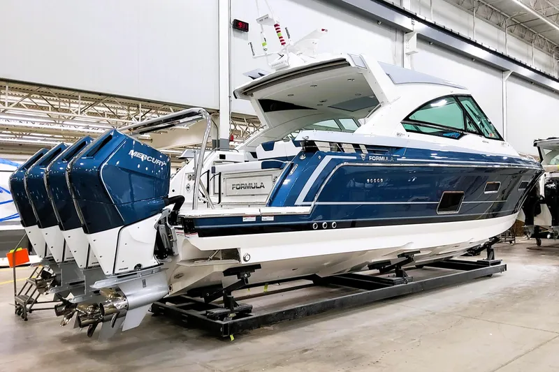 Slide: The Image of 2026 Formula 400 Super Sport Crossover boat with four Mercury outboard engines in a showroom. - 2