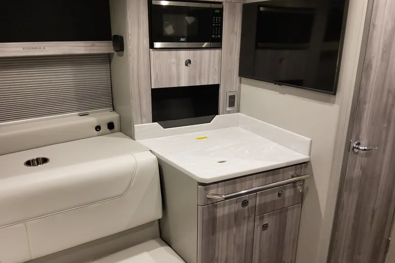 Slide: The Image of Interior of 2026 Formula 400 Super Sport Crossover with modern kitchenette and seating area. - 25