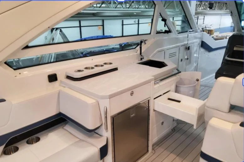 Slide: The Image of 2026 Formula 400 Super Sport Crossover interior with modern kitchenette and seating area. - 31