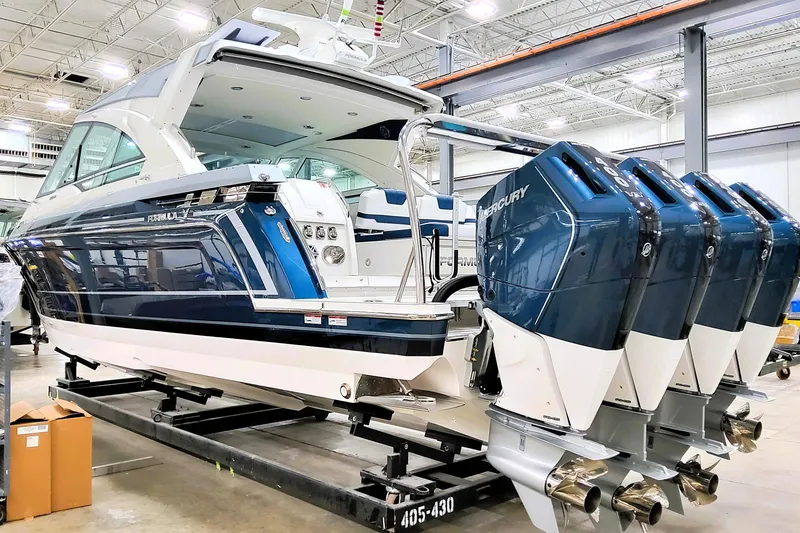 Slide: The Image of 2026 Formula 400 Super Sport Crossover boat with four Mercury outboard engines in a showroom. - 4