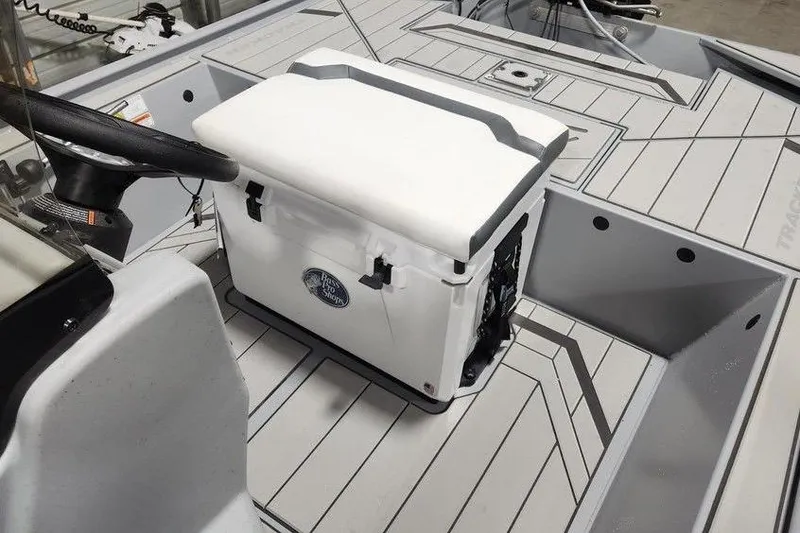 Slide: The Image of 2026 Tracker Bass Tracker Classic CC interior with cooler and steering wheel. - 13