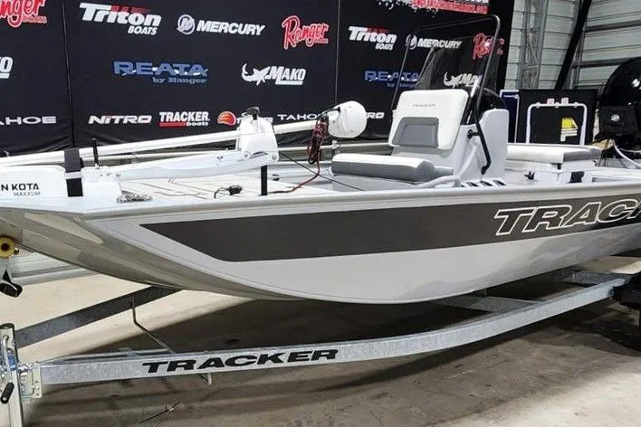Slide: The Image of 2026 Tracker Bass Tracker Classic CC boat on trailer in showroom setting. - 4