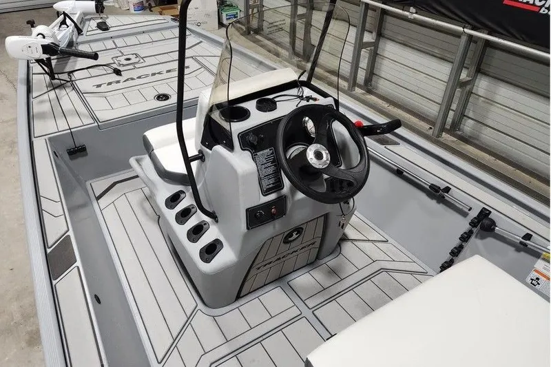 Slide: The Image of 2026 Tracker Bass Tracker Classic CC boat interior with steering console and seating. - 6