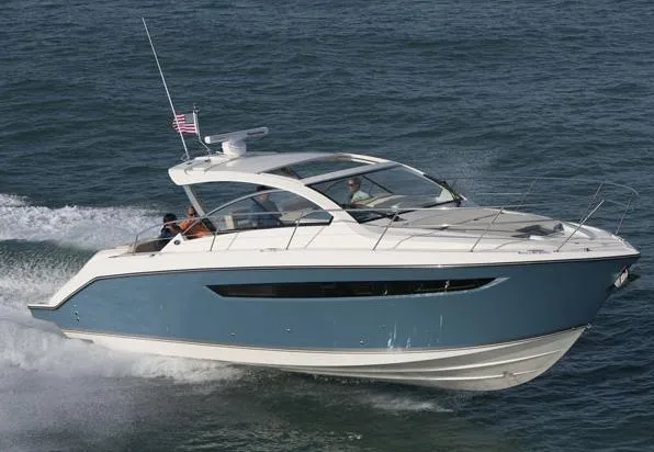 The Image of 2013 Pursuit SC 365i Sport Coupe docked at marina, clear sky background. - 0