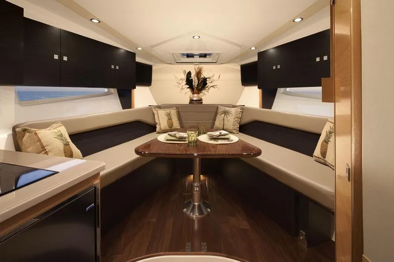 Slide: The Image of 2013 Pursuit SC 365i Sport Coupe helm seat and steering wheel, docked at marina. - 14