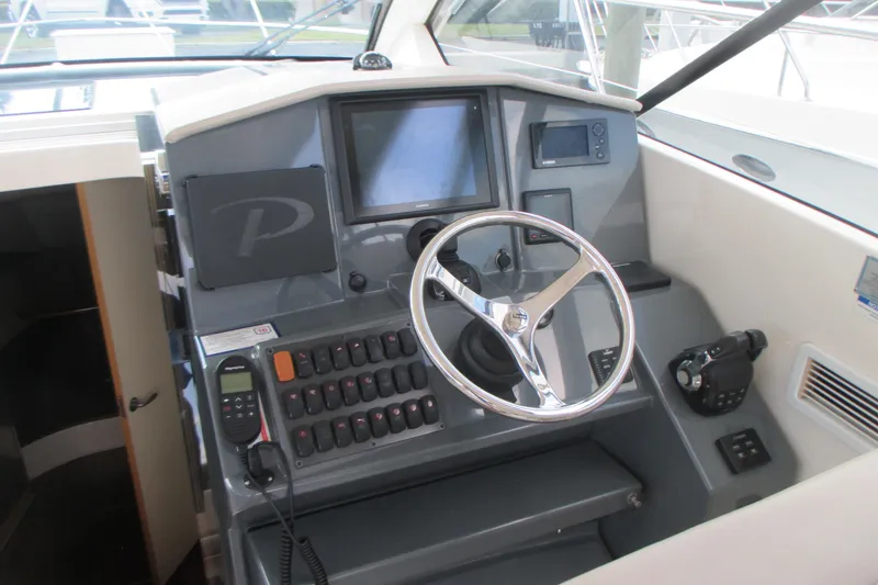 Slide: The Image of Cockpit of 2013 Pursuit SC 365i Sport Coupe with steering wheel and control panel. - 17