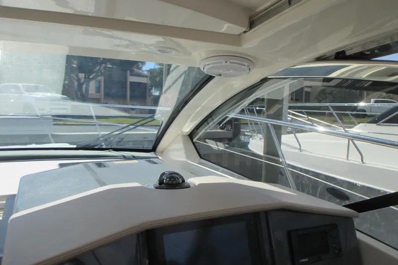 Slide: The Image of Interior view of 2013 Pursuit SC 365i Sport Coupe boat cockpit with navigation equipment. - 19