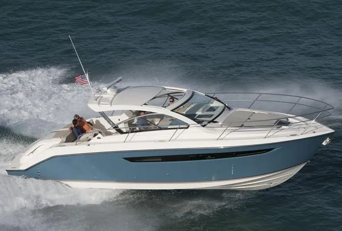 Slide: The Image of 2013 Pursuit SC 365i Sport Coupe docked at marina, front view with clear windshield. - 2