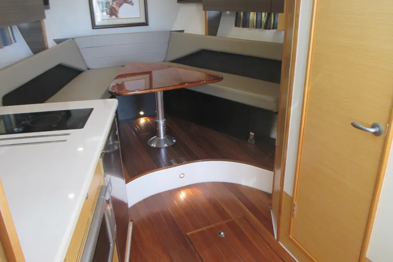 Slide: The Image of Interior of 2013 Pursuit SC 365i Sport Coupe with wood flooring and modern seating area. - 21