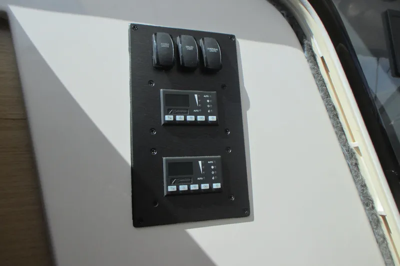 Slide: The Image of Control panel on 2013 Pursuit SC 365i Sport Coupe boat interior. - 24