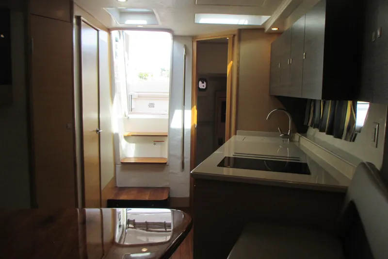 Slide: The Image of Interior of 2013 Pursuit SC 365i Sport Coupe, featuring modern kitchen and seating area. - 25