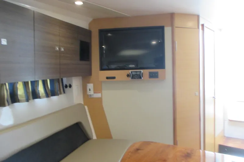 Slide: The Image of Interior of 2013 Pursuit SC 365i Sport Coupe with TV and seating area. - 35