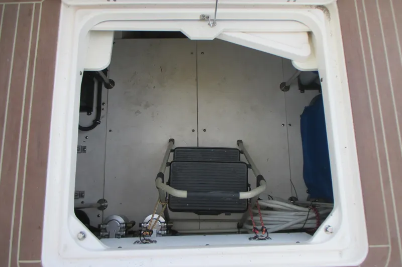 Slide: The Image of 2013 Pursuit SC 365i Sport Coupe storage compartment with ladder and equipment. - 36