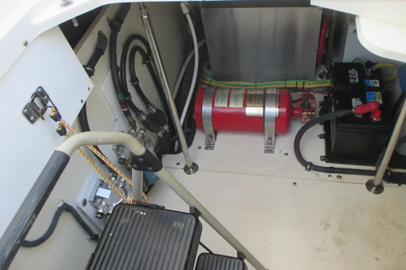 Slide: The Image of 2013 Pursuit SC 365i Sport Coupe engine compartment with fire extinguisher and battery. - 38