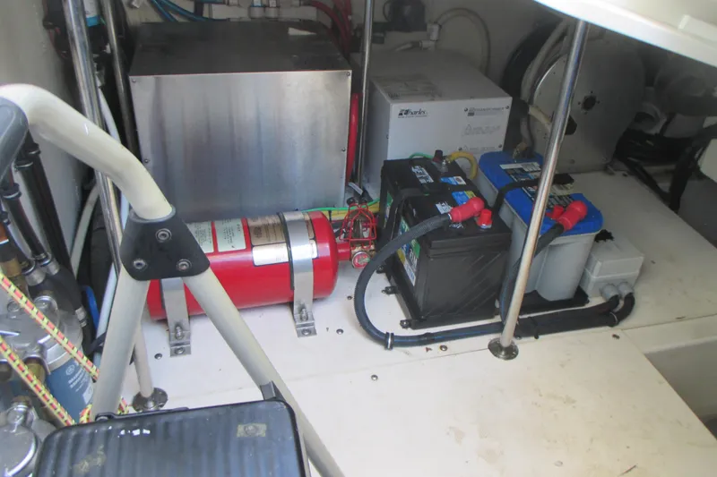 Slide: The Image of 2013 Pursuit SC 365i Sport Coupe engine compartment with batteries and fire extinguisher. - 39