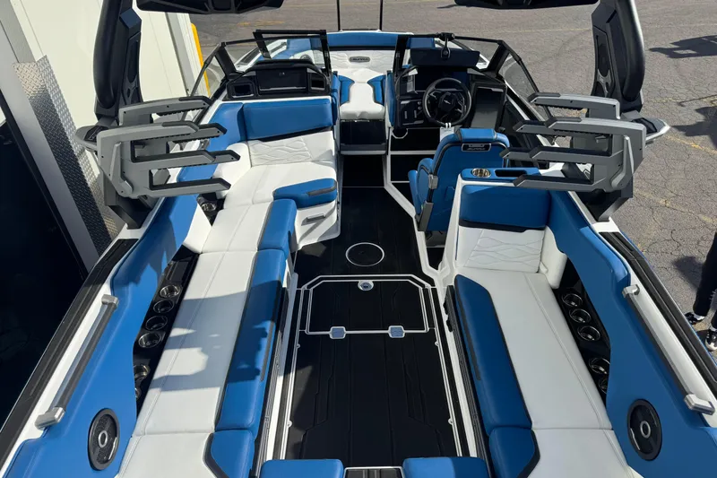 Slide: The Image of 2026 Supra SE 575 boat interior with blue and white seating, modern design, and spacious layout. - 4