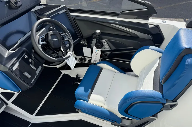 Slide: The Image of 2026 Supra SE 575 boat interior with blue and white seating, modern dashboard, and steering wheel. - 5