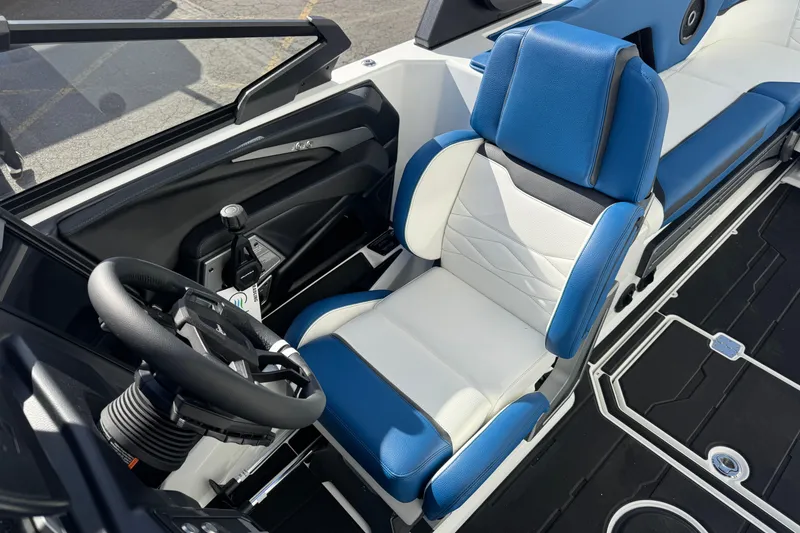 Slide: The Image of 2026 Supra SE 575 boat interior with blue and white seating and steering wheel. - 7