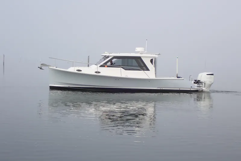 Slide: The Image of 2023 True North 34 Outboard Express boat on calm water, side view. - 1
