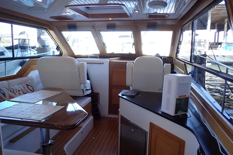 Slide: The Image of Interior of 2023 True North 34 Outboard Express boat with seating and table. - 10