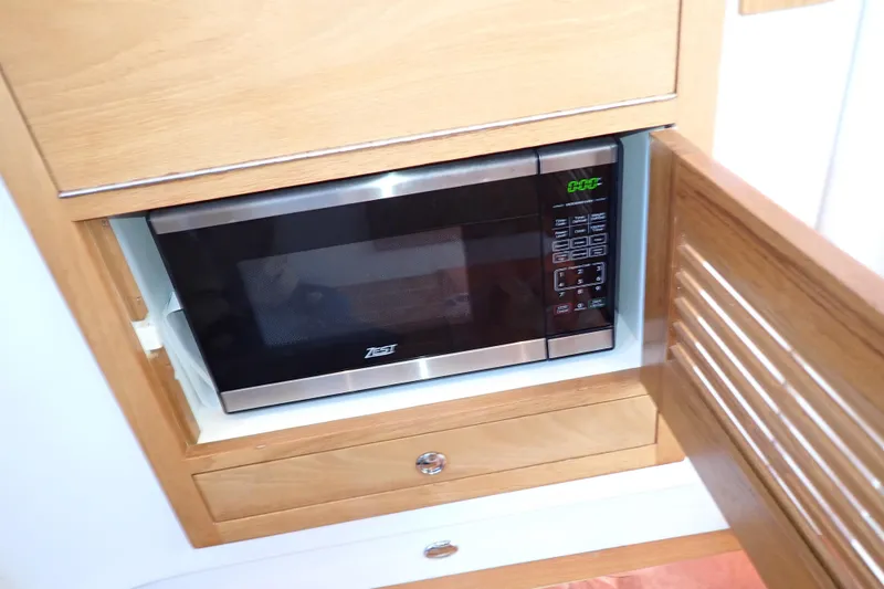 Slide: The Image of Microwave in 2023 True North 34 Outboard Express boat's wooden cabinet. - 100
