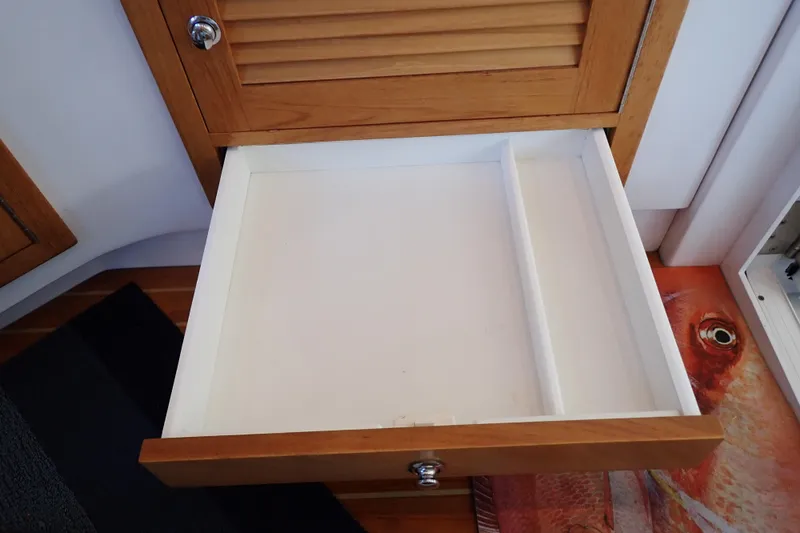 Slide: The Image of Open wooden drawer in 2023 True North 34 Outboard Express boat interior. - 102