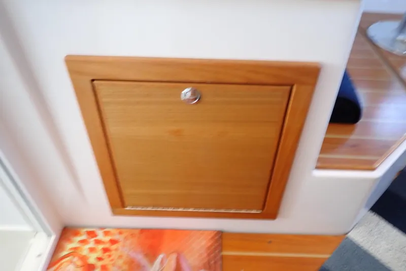 Slide: The Image of Wooden cabinet door on 2023 True North 34 Outboard Express boat interior. - 103